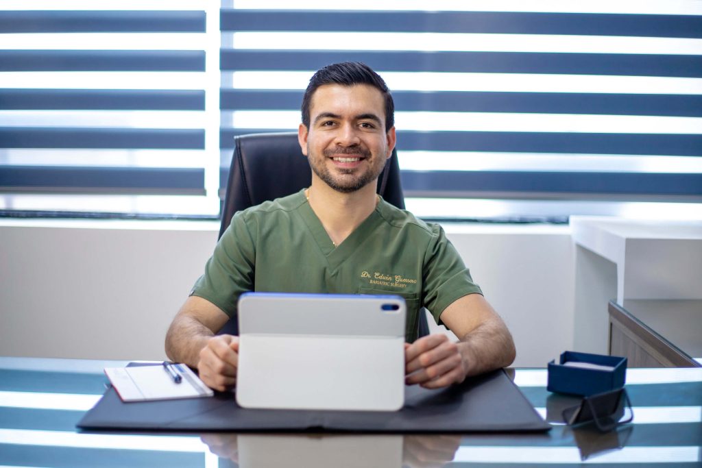 Dr. Edwin Guerrero Tijuana Bariatric Surgeon at Desk for Patient Consultation